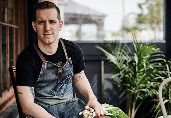 chef holding fresh scallions