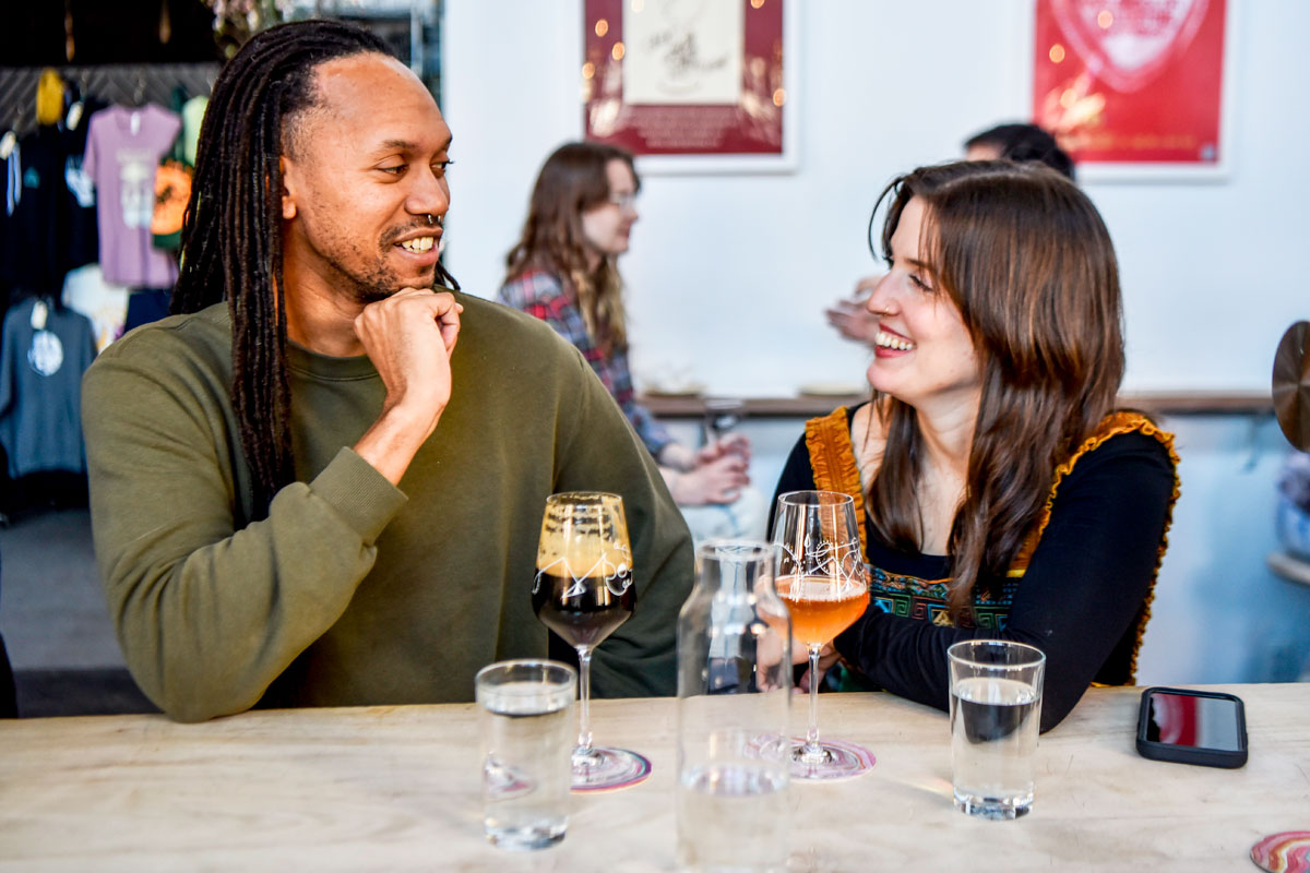 couple enjoying beer and water in a brewery taproom