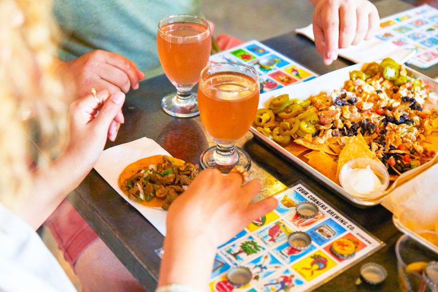 people playing bingo and drinking beer and eating nachos