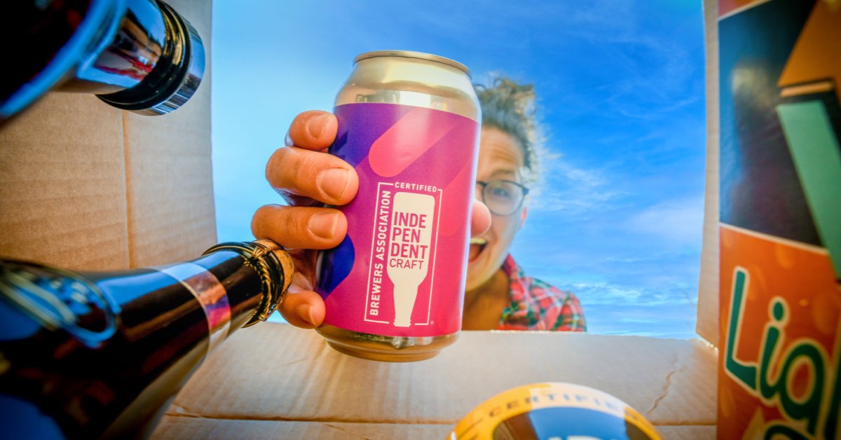 woman pulling beer out of box of beers